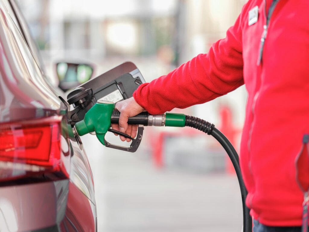 man pulling petrol in car